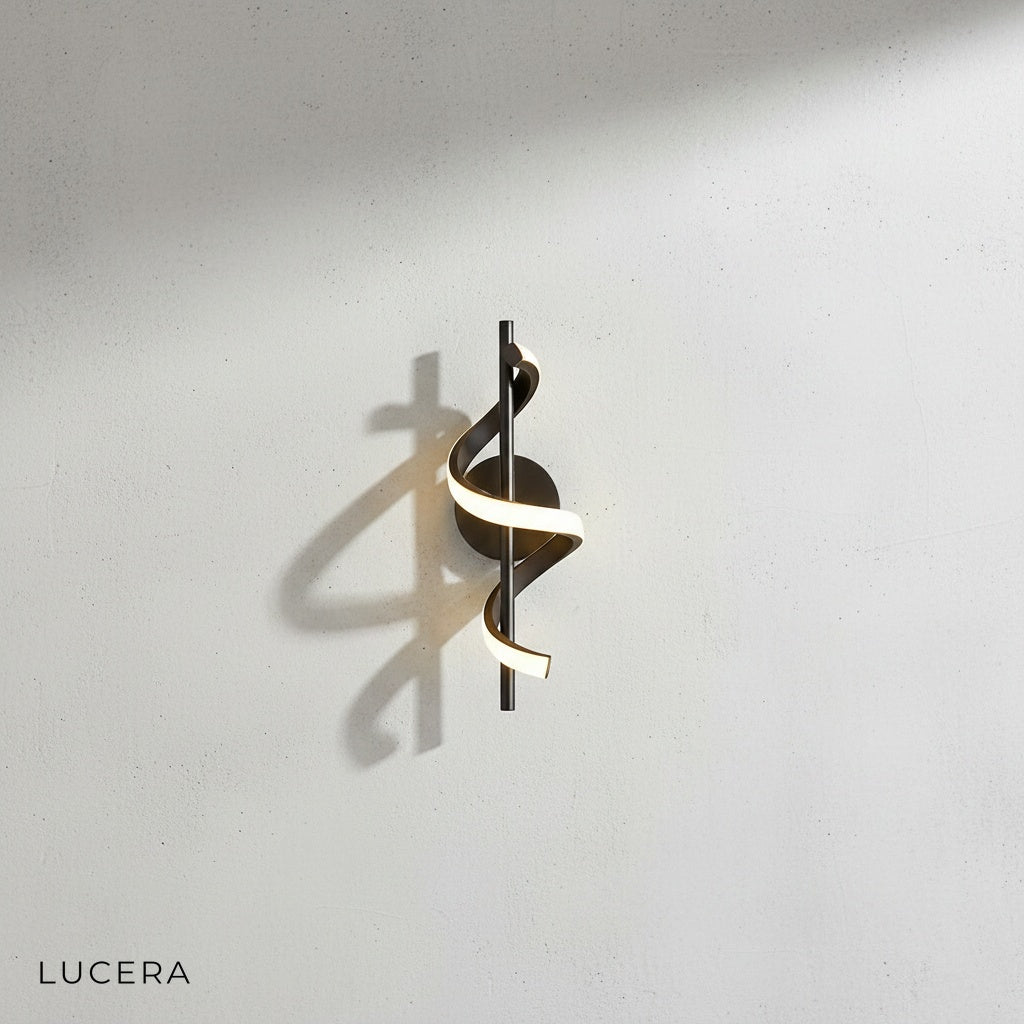 Crescendo LED wall sconce in black finish paired with gold variant on studio display