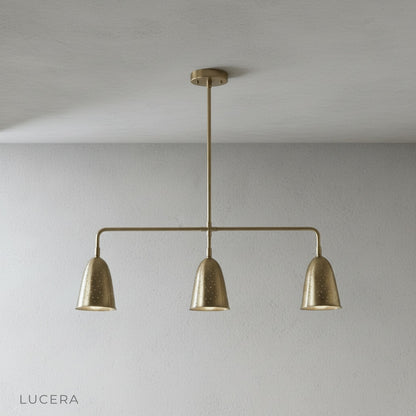 close-up of brass shade perforated detailing on whimsy linear chandelier