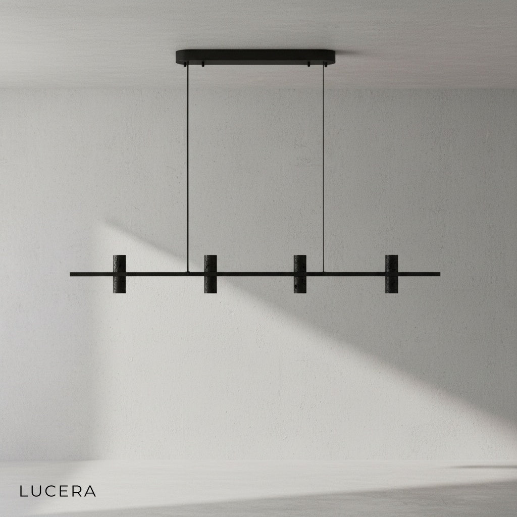 Feldgrau chandelier with warm glow over dining table in contemporary open-plan space