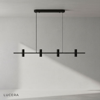 Feldgrau chandelier with warm glow over dining table in contemporary open-plan space