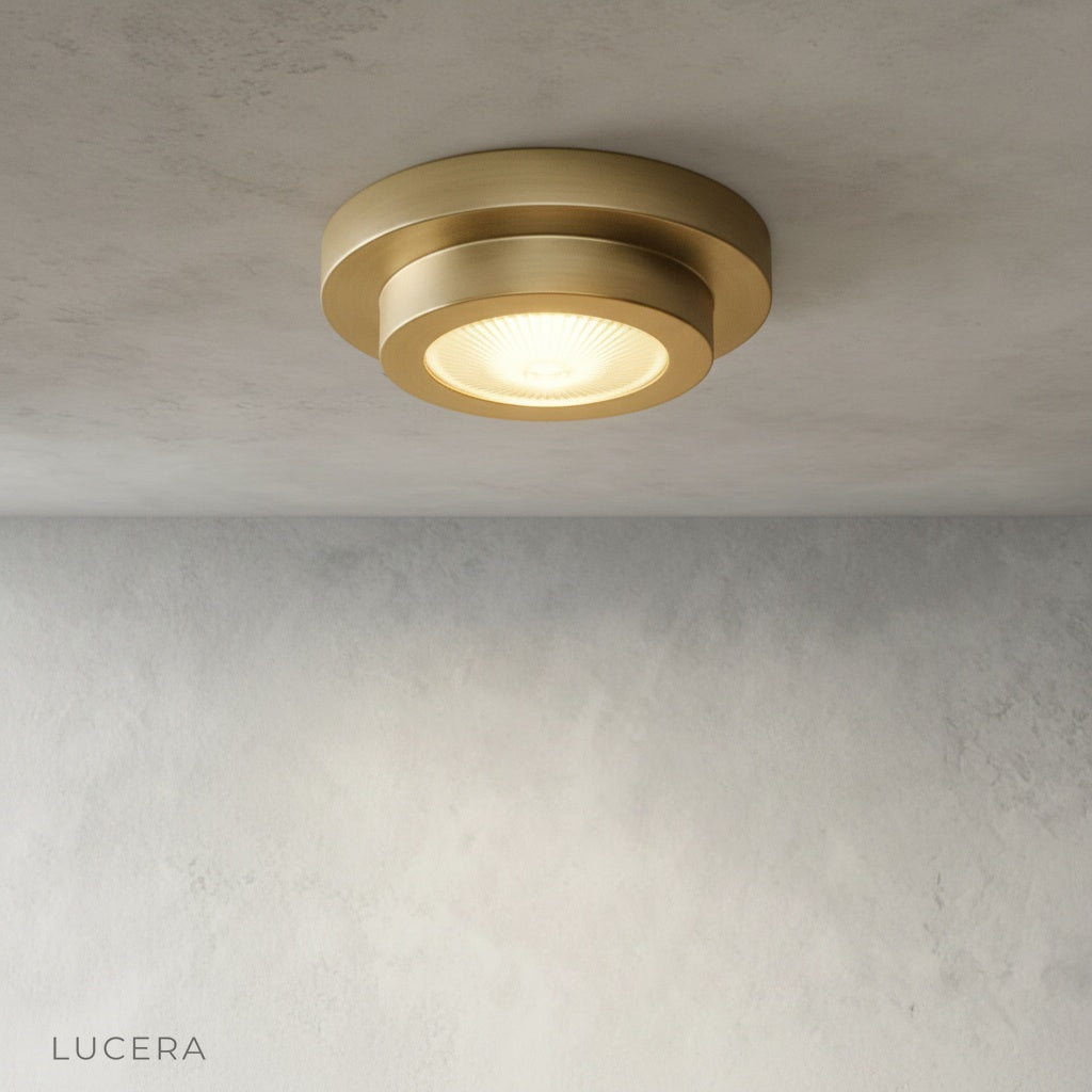 Close-up detail of solid brass hardware and cerulean blue paint texture on ceiling lamp