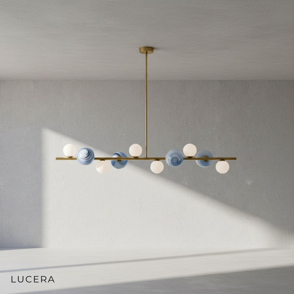 Ran Linear Chandelier in gold finish against a clean beige studio backdrop
