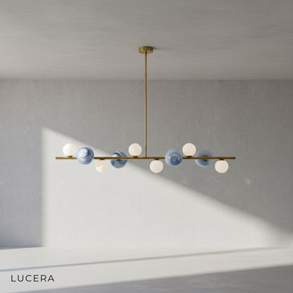 Ran Linear Chandelier in gold finish against a clean beige studio backdrop