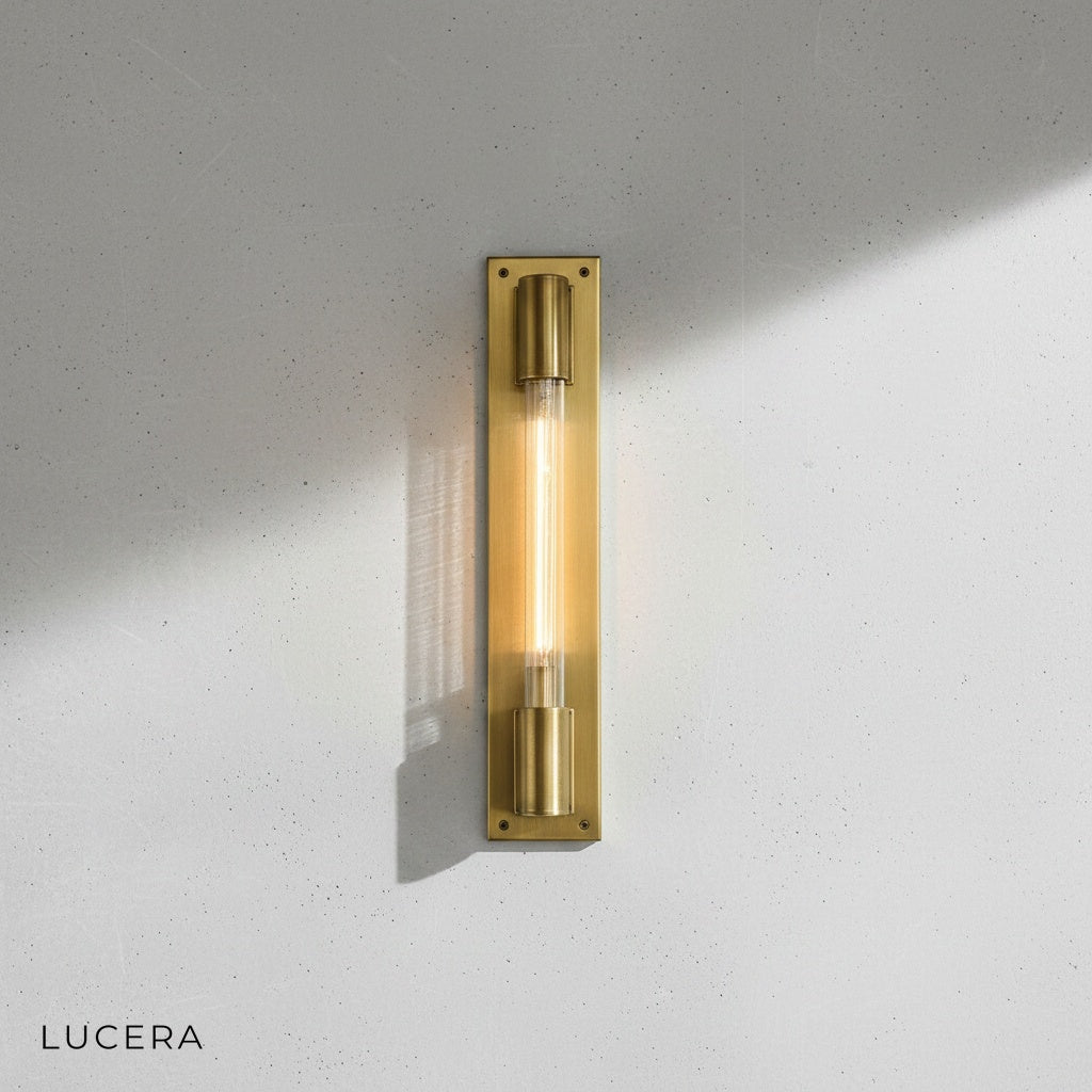Verve wall lamp in bronze finish mounted on dark tile wall with soft ambient shadow