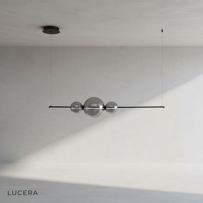 Bjorn chandelier in matte black finish suspended in a bright white studio room
