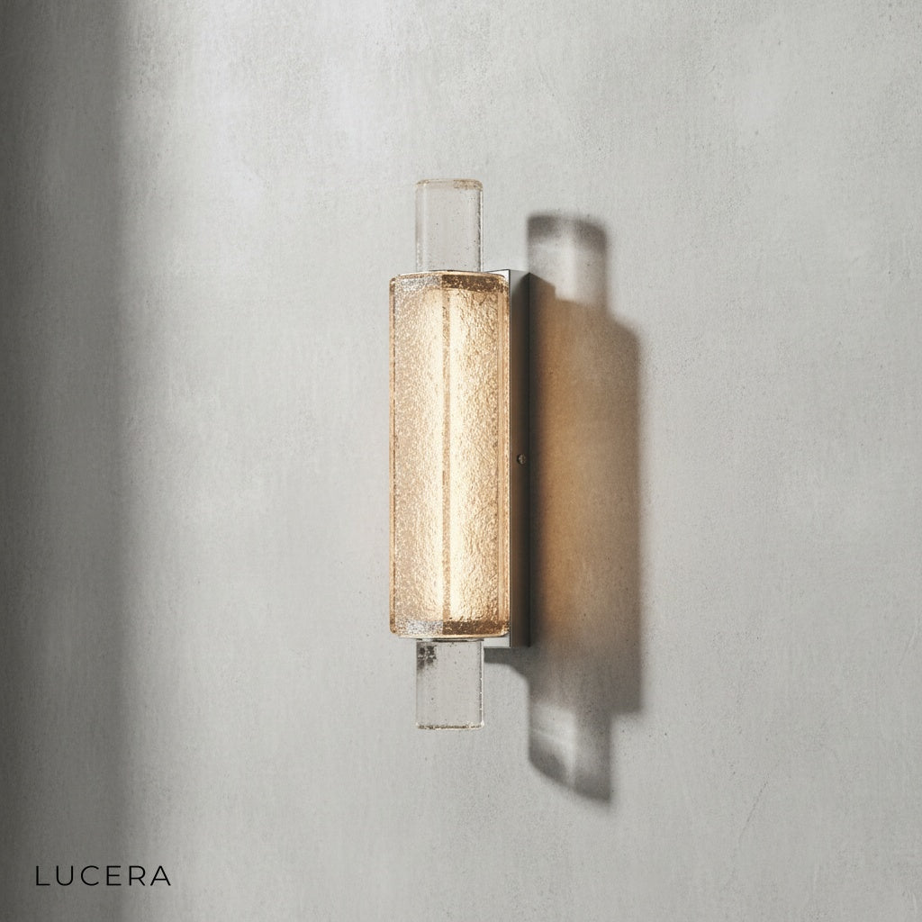 Accelerando wall lamp in cool white glow against dark wall for contrast