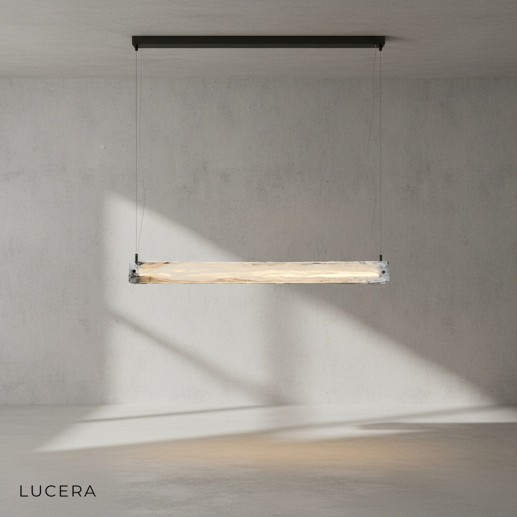 Lapis chandelier hanging over dining table with warm ambient light in minimalist interior