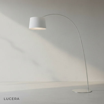 overhead angle of minimalist arc lamp casting soft diffused glow on wooden floor