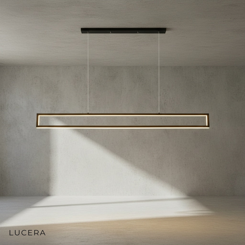 Ingrid chandelier hanging above a modern kitchen island with warm ambient light and sleek stools