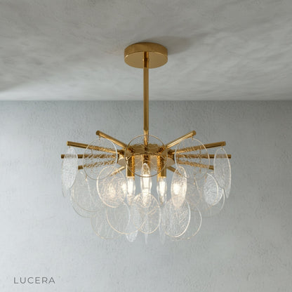 close-up of bubbled glass discs refracting light on gold chandelier