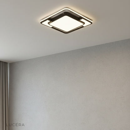 front view of round black LED ceiling fixture with striking geometric pattern in minimalist studio setting