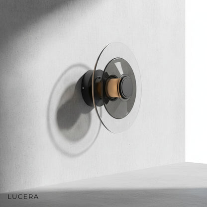Domo Disc amber glass sconce illuminating cozy reading nook with soft 3000K halo