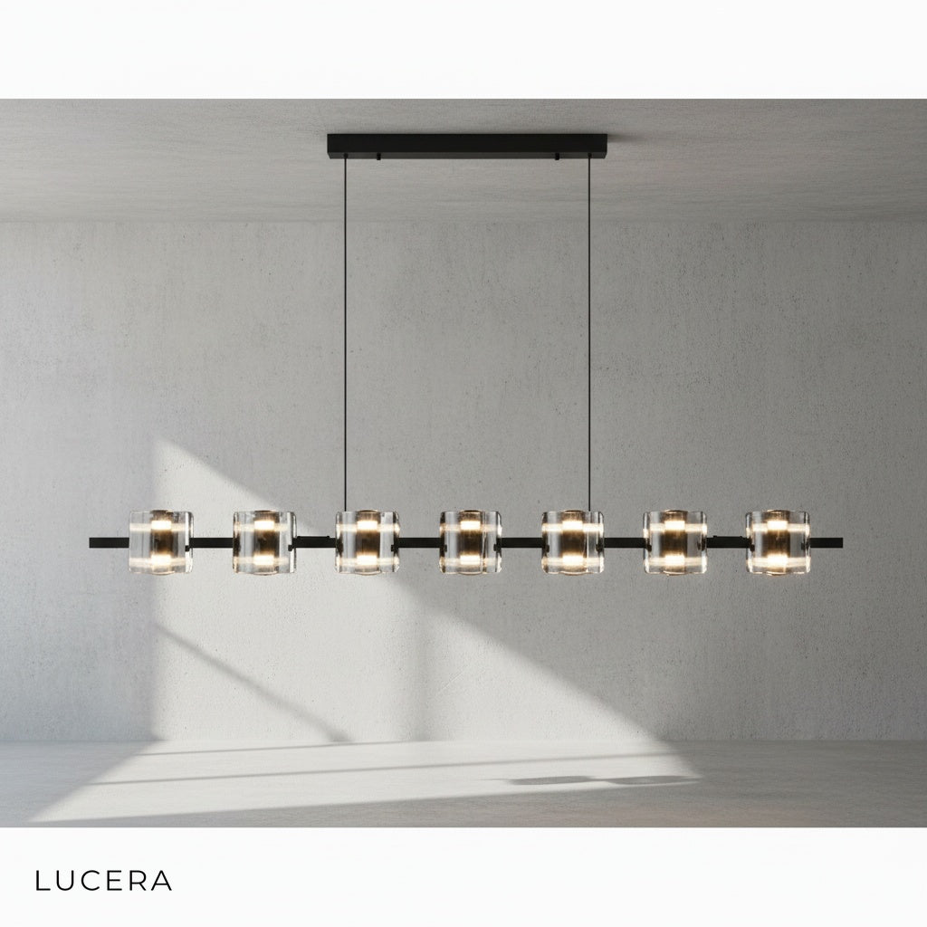 Rectangular glass chandelier hanging over kitchen island with pendant rods visible