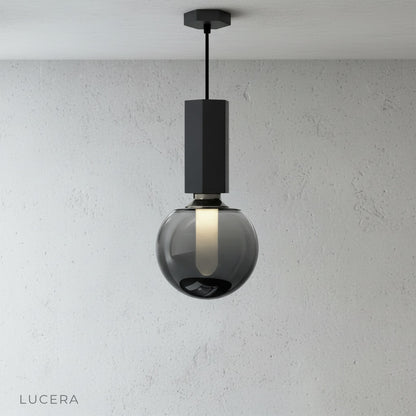 close-up of Ivan pendant light metal and concrete texture with warm bulb glow