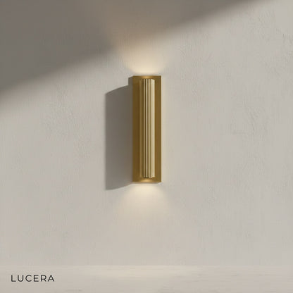 Loano wall lamp illuminating bedroom bedside with warm inviting glow at night