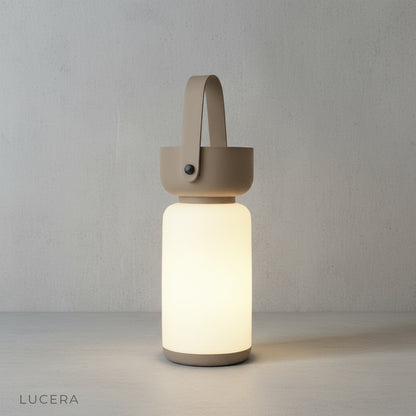 Rechargeable Basilica Table Lamp with sleek transparent body on neutral studio backdrop