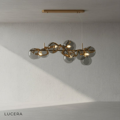 Calmo chandelier with white glass panels hanging above kitchen island with stools