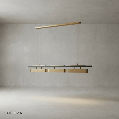 Oskar chandelier with black finish variant hanging over a kitchen island in bright daylight