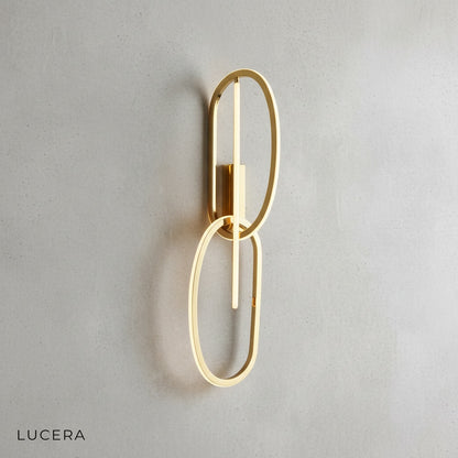 transverse wall lamp in warm white finish mounted above modern bedroom nightstand