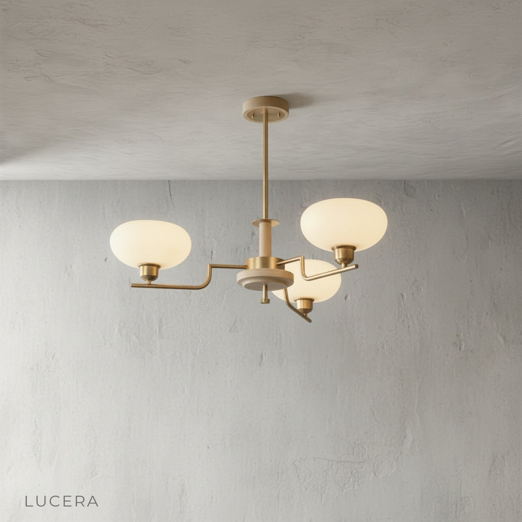 close-up detail of brass arm joint and smoked glass globe shade on Eronix chandelier