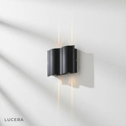 Sleek black outdoor wall lamp with frosted LED panel, side angle studio view