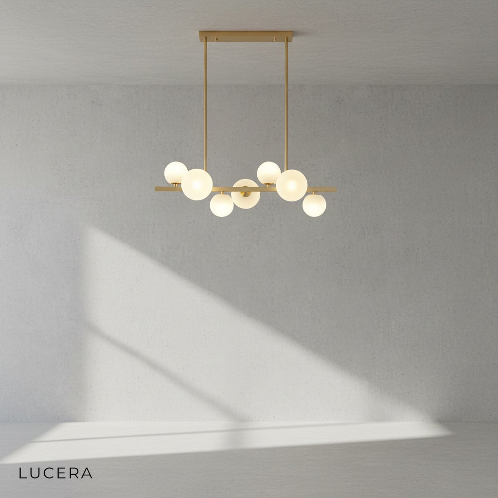 Seven-light configuration of the Nord Gold Pearls Chandelier in a bright dining room