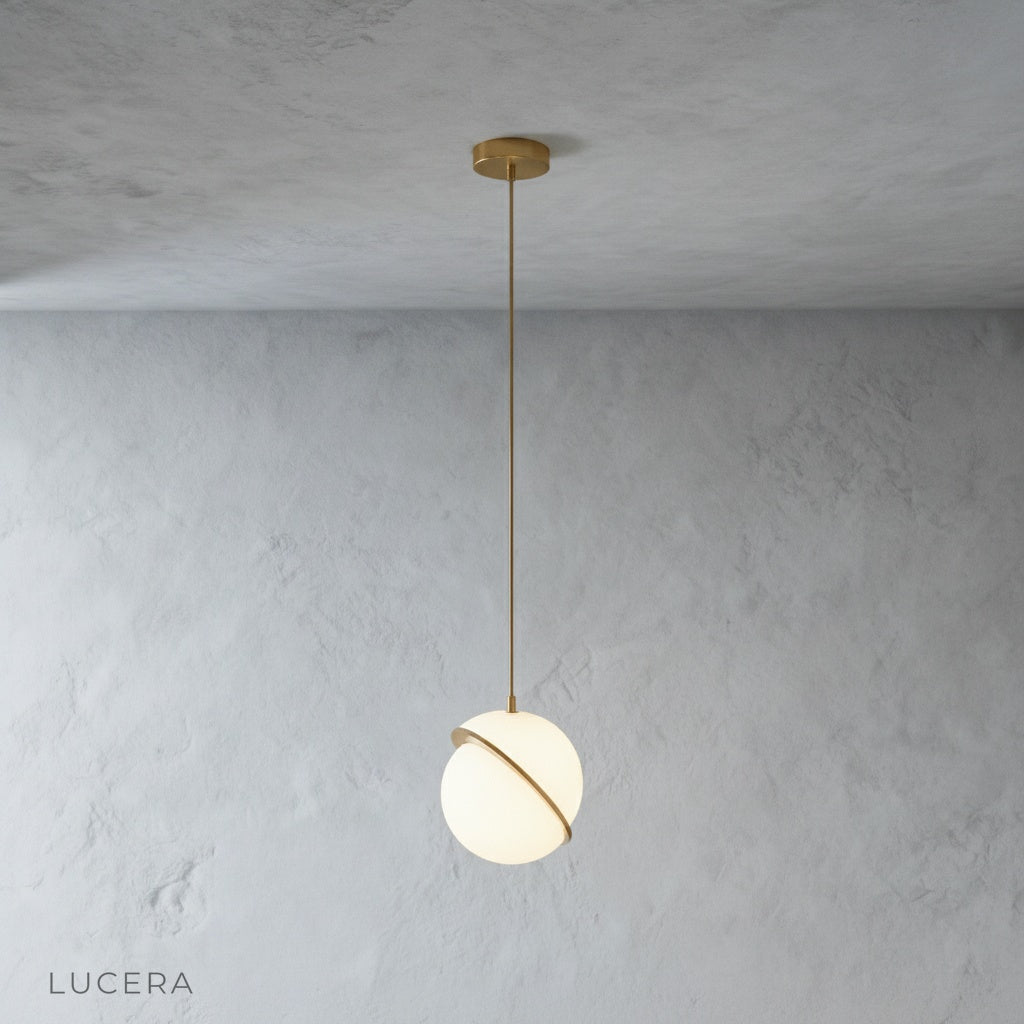 Close-up of Igneous pendant light polished brass iron top and white acrylic texture