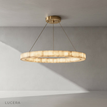 Close-up of the natural calcite stone texture on the Bamboo Round Chandelier with warm light passing through