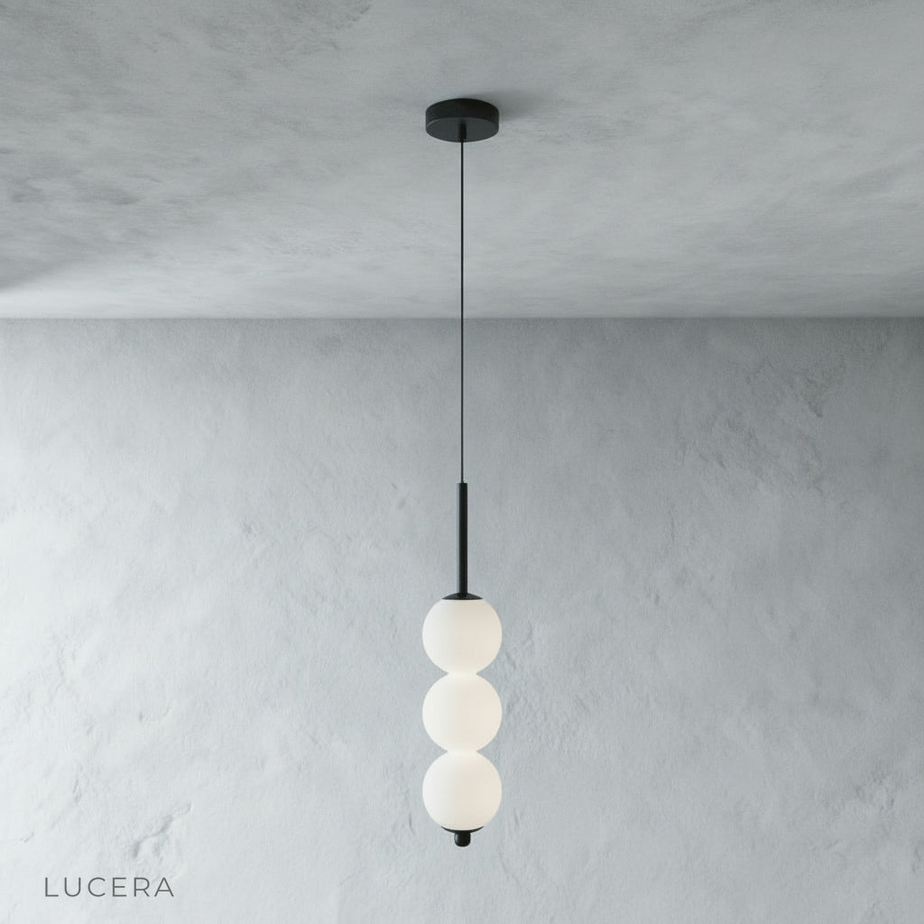 close-up of Meridian Pendant Light copper frame joint and glass ball shade texture