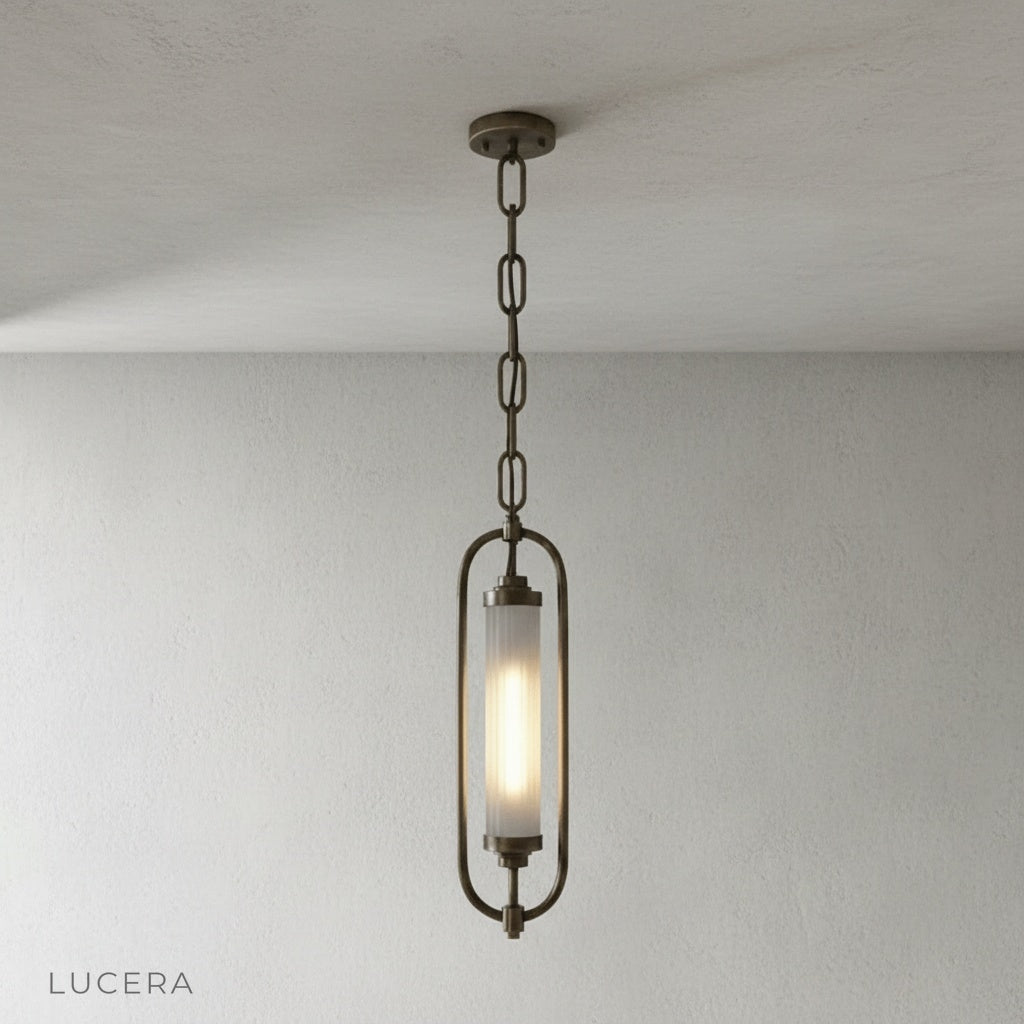 close-up detail of ribbed glass diffuser and warm 2700K light inside brass oval frame