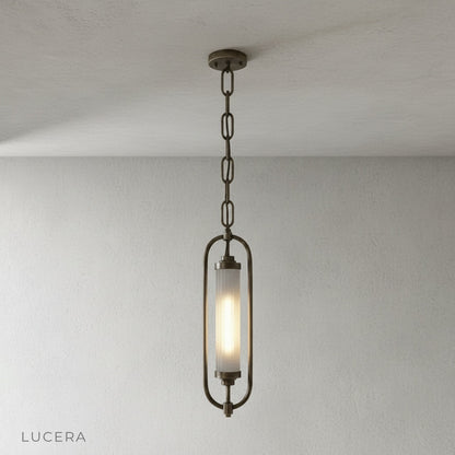 close-up detail of ribbed glass diffuser and warm 2700K light inside brass oval frame