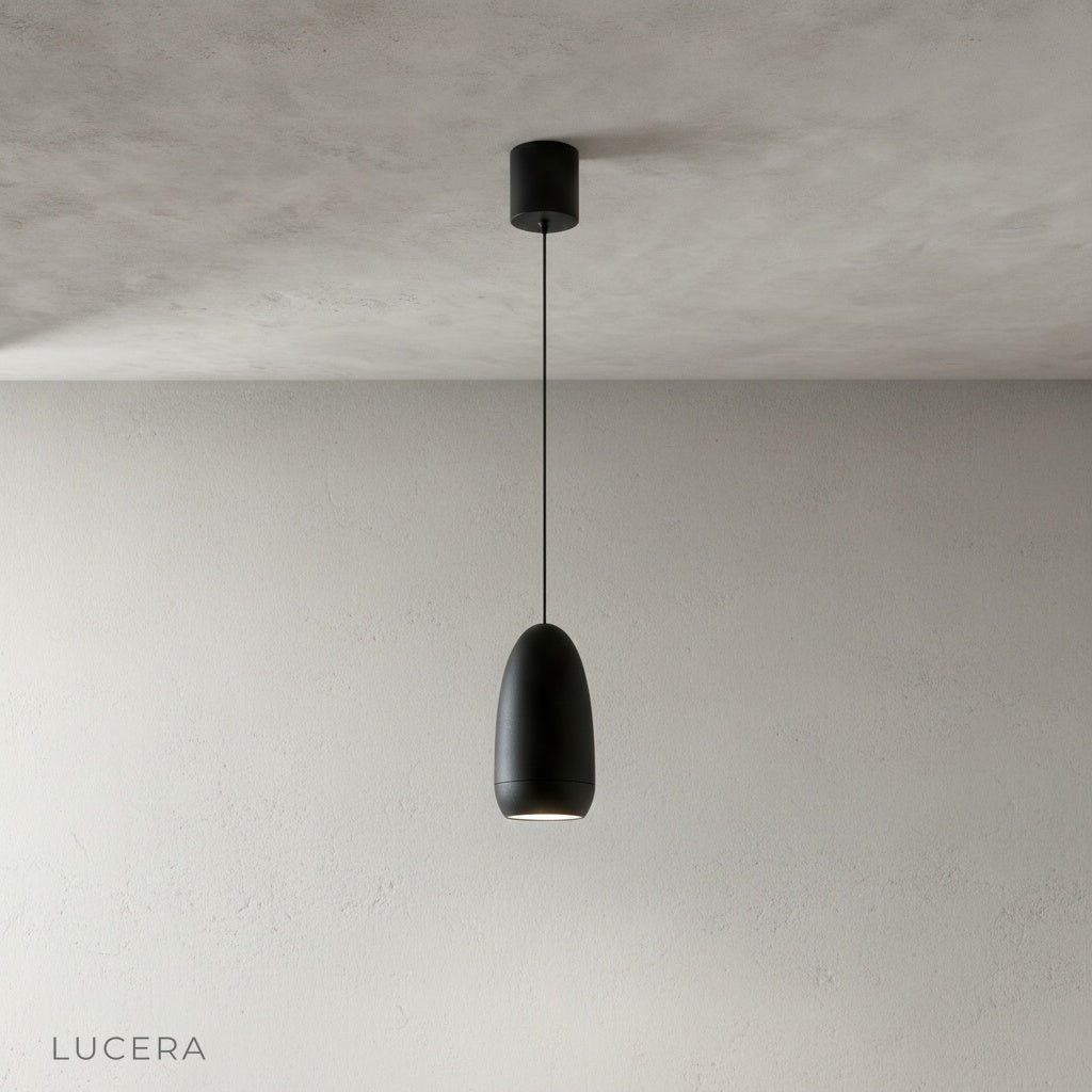 close-up of matte aluminum capsule pendant light shade with visible suspension cord