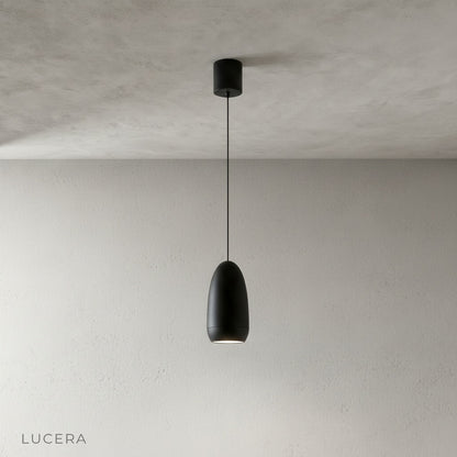 close-up of matte aluminum capsule pendant light shade with visible suspension cord