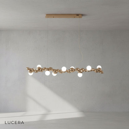 alternate brushed nickel finish of Byzantium long chandelier with warm Edison bulbs lit