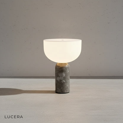 portable Stringendo LED table lamp on a bedroom nightstand casting soft ambient glow