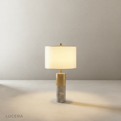 Essere Table Lamp on wooden desk in home office with warm ambient lighting and books