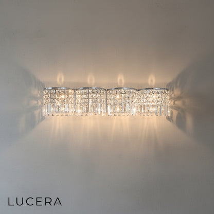 Detailed macro shot of crystal droplets catching light on the Vibrato luxury sconce