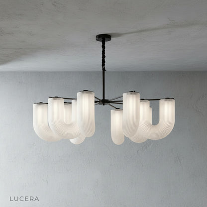 Thalassa chandelier in black finish hanging above a dining table in a contemporary space