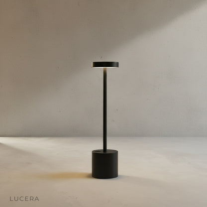 Sinkhole Table Lamp with warm light on bedside table in cozy bedroom