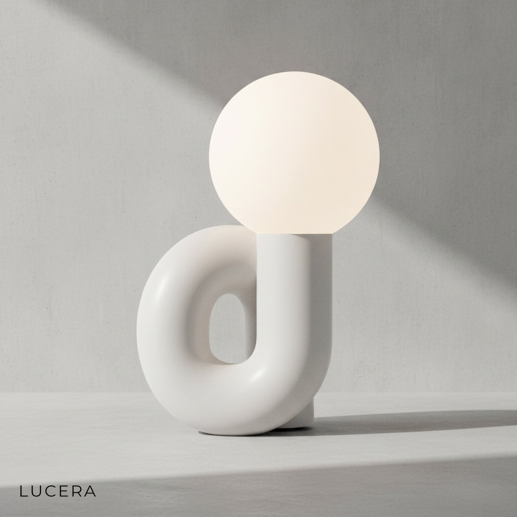 overhead view of Precipitando white resin lamp on marble console with subtle reflections