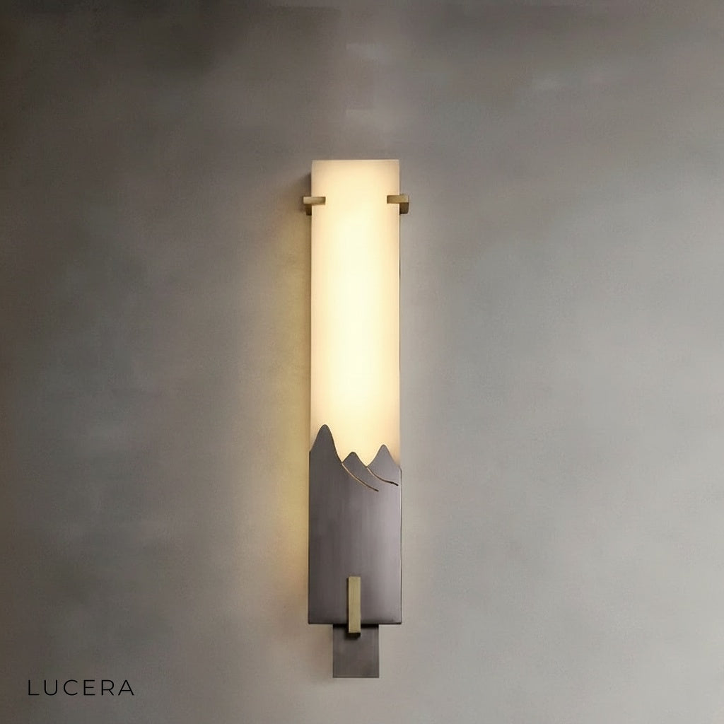 Axonal wall lamp above bedside table in serene bedroom with soft evening ambiance