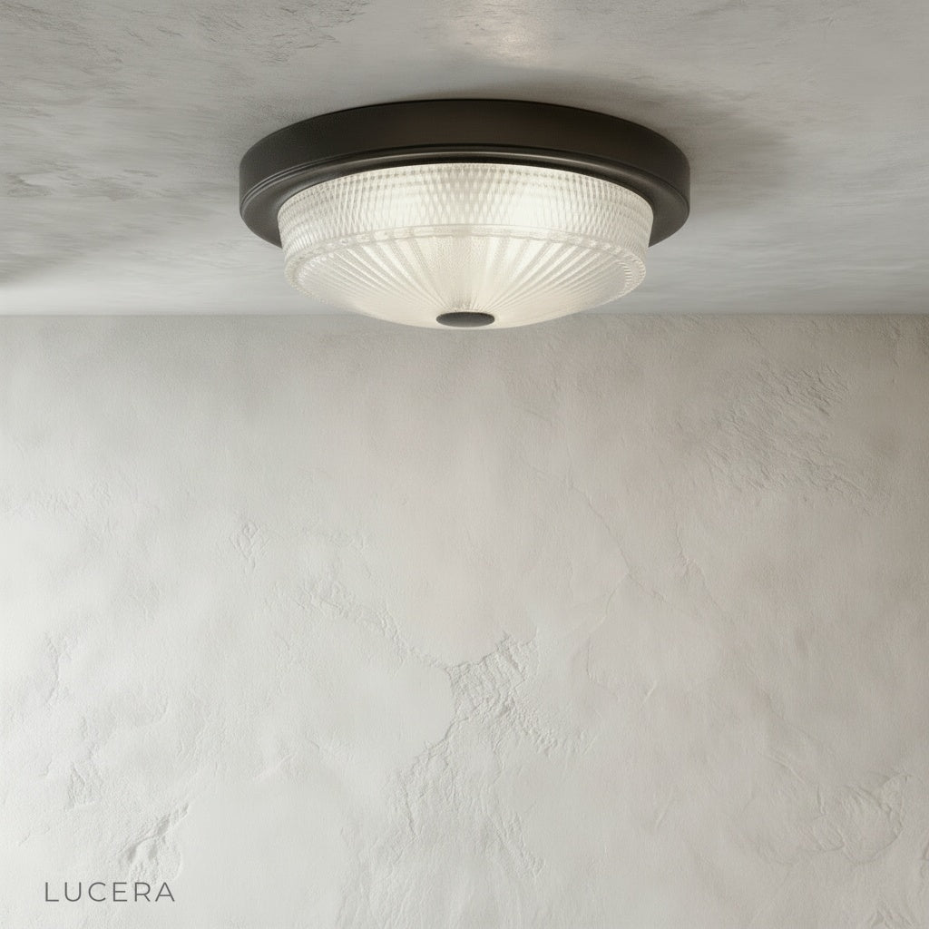 Close-up of Veneration ceiling light glass shade revealing soft light diffusion and sleek metal ring