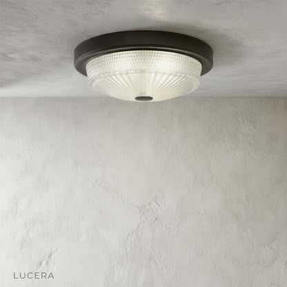 Close-up of Veneration ceiling light glass shade revealing soft light diffusion and sleek metal ring