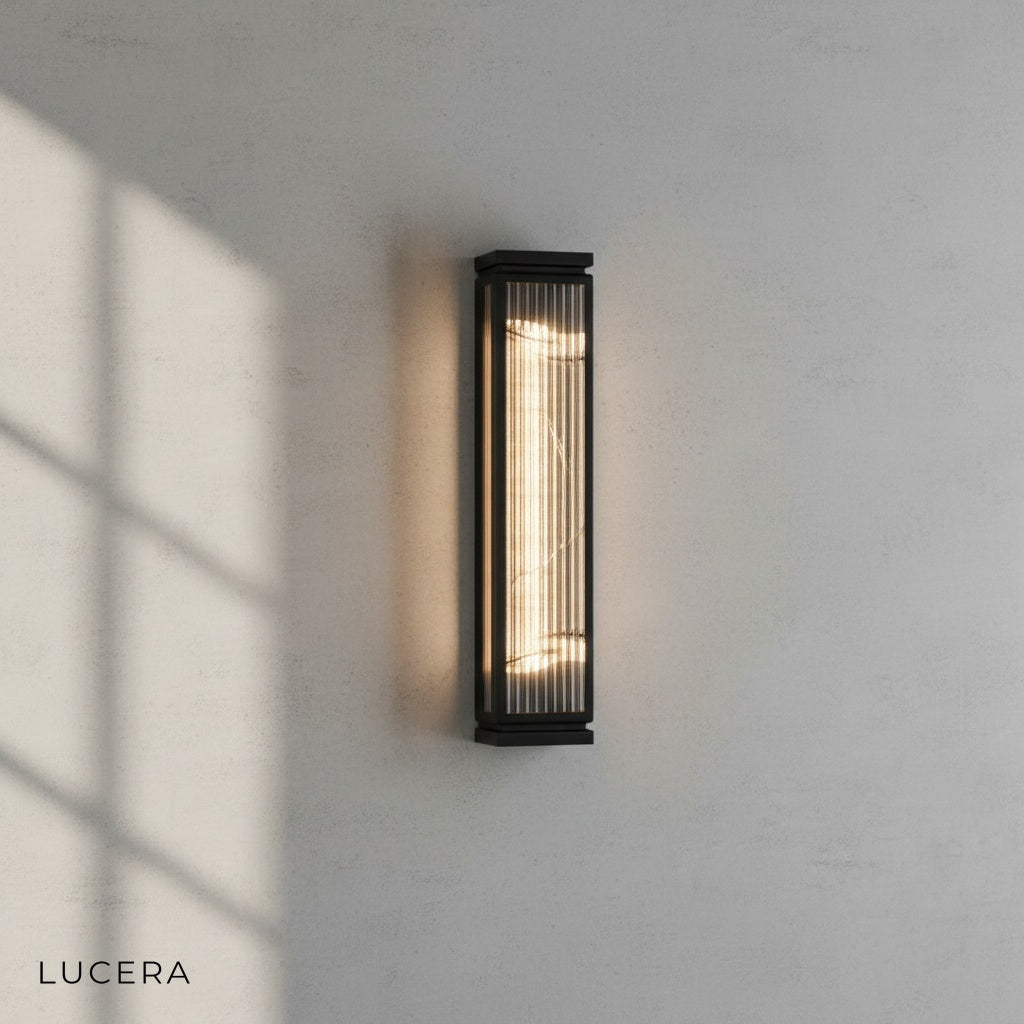 minimalist wall sconce with marble accent above an outdoor lounge chair