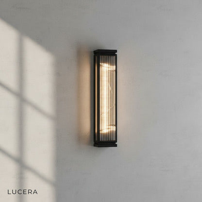 minimalist wall sconce with marble accent above an outdoor lounge chair