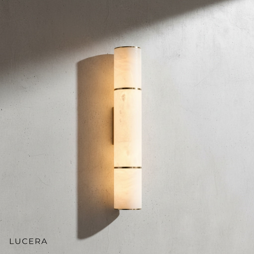 small Vague marble wall lamp casting warm glow in cozy reading nook with linen armchair