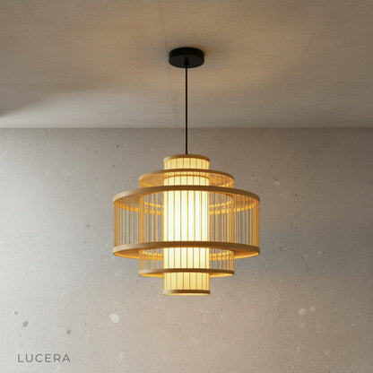 pair of rattan pendant lights hanging at different heights in warm neutral dining room