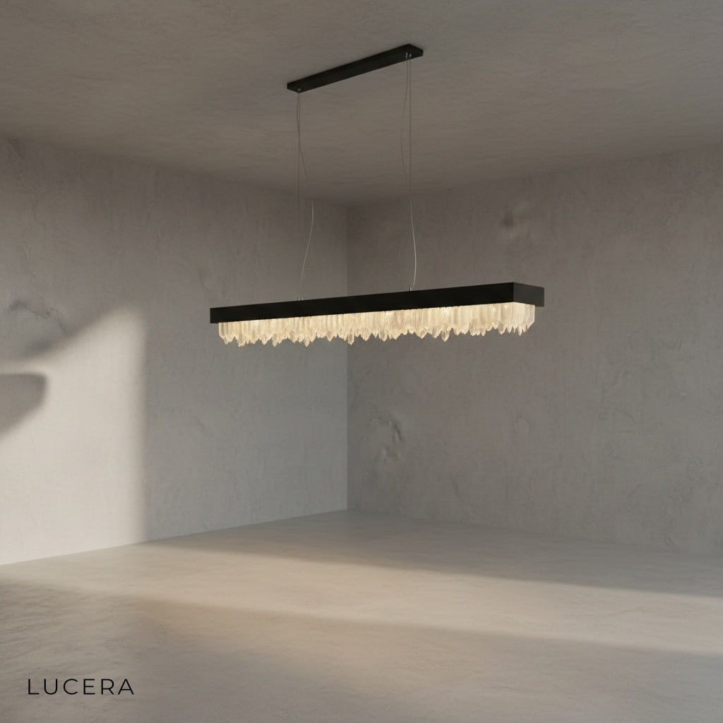 modern crystal chandelier hanging over kitchen island with adjustable cord visible