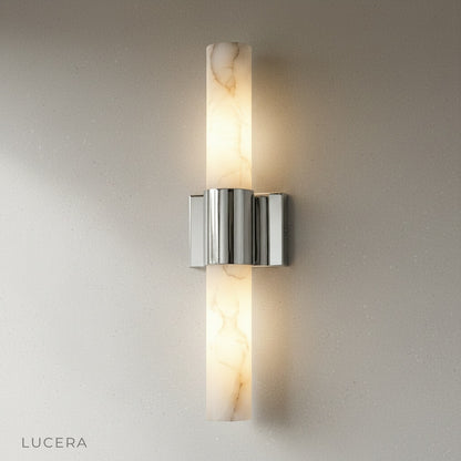 Pair of Umbra Alabaster wall sconces flanking a hallway mirror with warm light