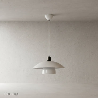 Eburnean pendant light in warm white finish hanging over minimalist bedside table